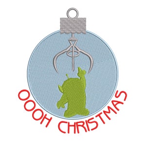 May include: A blue Christmas ornament with a green alien inside and a silver claw above it. The text "OOOH CHRISTMAS" is written around the ornament in red.