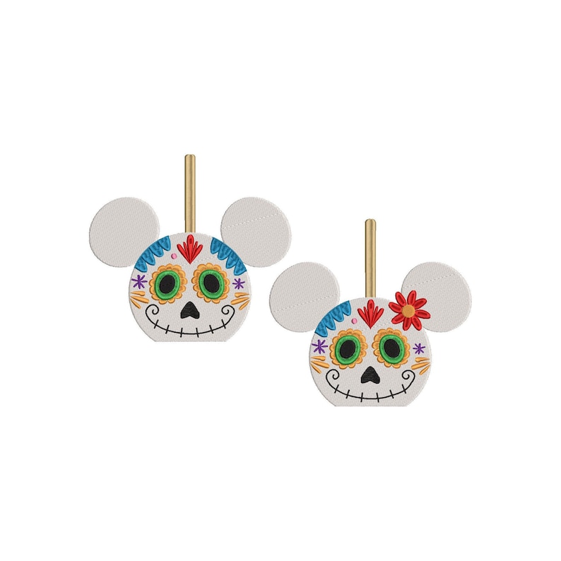 May include: Two white Mickey Mouse-shaped ornaments with Day of the Dead sugar skull faces. The skulls have green eyes, red lips, and colorful floral designs.