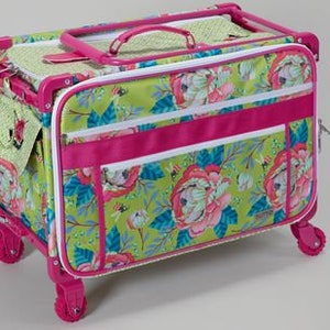 May include: A rolling tote bag with a floral pattern in shades of green, pink, and blue. The bag has a pink frame, handle, and wheels. It features multiple zippered compartments and a small side pocket.