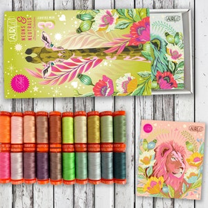 May include: A set of 12 spools of Aurifil thread in a variety of colors, including pink, green, orange, and blue. The spools are arranged in two rows of six. The thread is 100% cotton and is made in Italy. The spools are labeled with the Aurifil logo and the color number. The thread is packaged in a box with a colorful design featuring a giraffe and flowers.