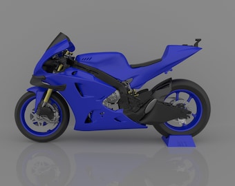 May include: A blue and black motorcycle with a sleek design. The motorcycle is on a stand and has a blue and black color scheme.