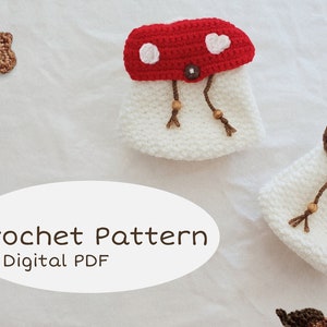 May include: Crochet pattern for mushroom-shaped pouches. The pouches are white with red or brown mushroom caps. The red caps have white circles and hearts. The image also includes crochet leaves and acorns. Text on the image reads "Crochet Pattern * Digital PDF."