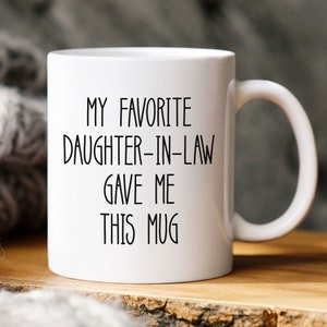 May include: White ceramic mug with black text that reads "My favourite daughter-in-law gave me this mug".