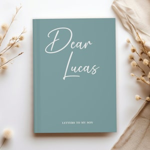 May include: A light blue journal with the text "Dear Lucas" and "Letters to My Son" in white.