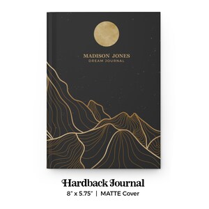 May include: Black hardback journal with a gold mountain range design and a full moon. The text "MADISON JONES DREAM JOURNAL" is printed on the front cover. The journal measures 8 inches by 5.75 inches.