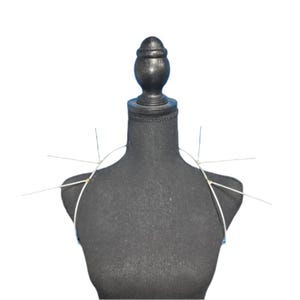 May include: A black fabric dress form with a wire frame for creating a garment. The wire frame is attached to the shoulders of the dress form.