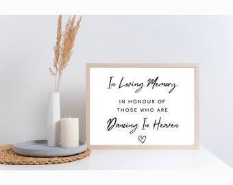 May include: A framed sign with the text "In Loving Memory, In Honour Of Those Who Are Dancing In Heaven" with a small heart symbol.