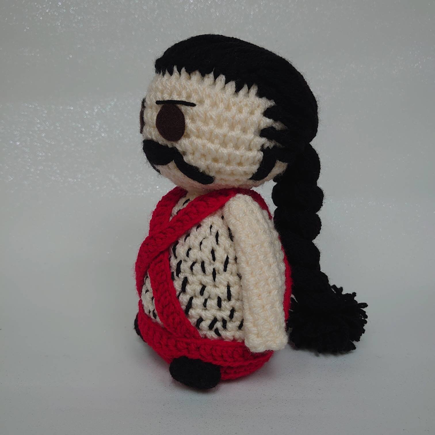 Sean Connery inspired crochet doll dressed in his iconic blue romper