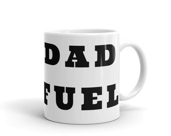 May include: White ceramic coffee mug with black text that reads "DAD FUEL".