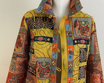 May include: A yellow, brown, and orange patterned jacket with colorful embellishments and a button closure. The jacket has a mandarin collar and long sleeves.