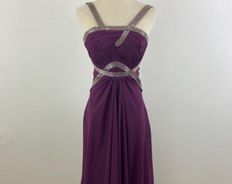 May include: A long, purple, sleeveless dress with a silver beaded design across the bodice and straps.