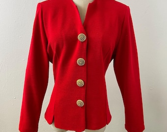 May include: A bright red long-sleeved blazer featuring a subtle horizontal ribbed texture, a collarless V-neckline, and four large, round, gold-toned metal buttons with a decorative open-work lattice pattern down the center front closure.