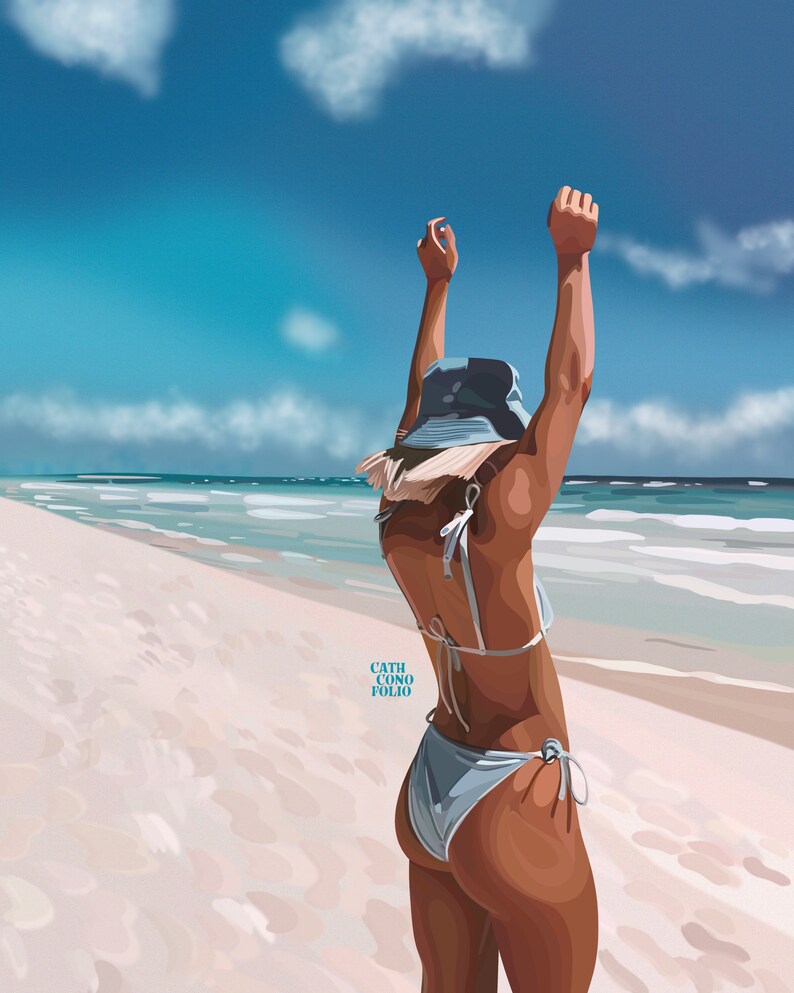 May include: A woman wearing a blue bikini and a blue bucket hat stands on a white sandy beach with her arms raised in the air. The ocean is in the background.