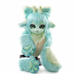 May include: A plush creature head and paw set featuring long, soft faux fur in shades of mint green and pale yellow. The head has large, expressive dark green eyes with white highlights, pointed ears, and a small pink nose. Two matching furry paws.