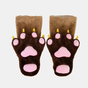 May include: A pair of plush brown animal paw gloves featuring dark brown fur, light pink padded paw pads, and yellow claws. The gloves have a lighter brown cuff at the top and a soft, fuzzy texture throughout the entire surface of the hand coverings.