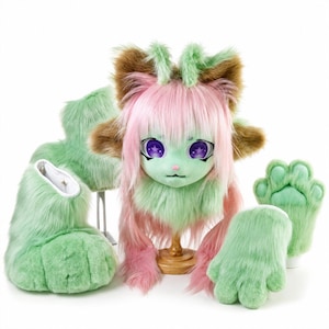 May include: A faux fur costume set featuring a mint green and pink animal head mask with large purple star-patterned eyes, long pink hair, and brown ear accents. The set includes matching mint green plush paw gloves and large furry foot covers.