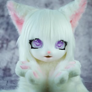May include: A white furry animal with pink ears and paws, wearing a white fur head with purple eyes and a pink nose. The animal is looking directly at the camera.
