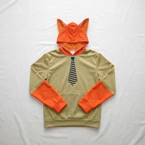 Close-up of the unlined, breathable heavy-blend fabric on a custom fursona sweatshirt, showing the durable stitching on the animal ears.