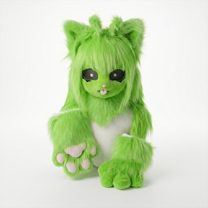 May include: A lime green furry creature costume with large paws and a head with long, shaggy hair. The costume has black eye details, a pink nose, and a tongue sticking out. The paws have pink pads.