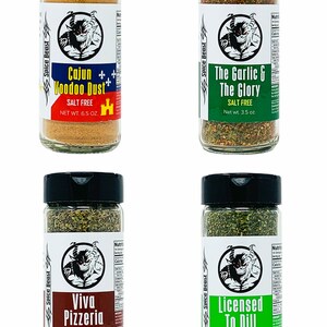 May include: Four glass spice jars with black lids and labels. Each jar contains a different blend of spices. The labels feature a cartoon devil and the names of the spice blends: Cajun Voodoo Dust, The Garlic & The Glory, Viva Pizzeria, and Licensed To Dill. All blends are salt-free.