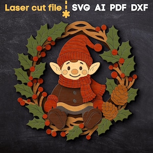 May include: A laser-cut Christmas elf design. The elf wears a red hat and scarf, sitting inside a wreath of green leaves and red berries. The text "Laser cut file" and file type options are at the top.