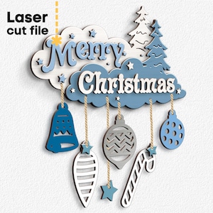 May include: A wooden Christmas decoration with the words "Merry Christmas" in white and blue. The decoration includes hanging ornaments, stars, and a Christmas tree design. The words "Laser cut file" are also visible.