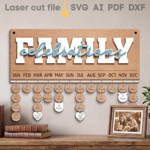 May include: A wooden family celebrations calendar with the word "FAMILY" in white block letters and "celebrations" in cursive blue letters. Includes wooden discs with names and dates, and a framed family photo.