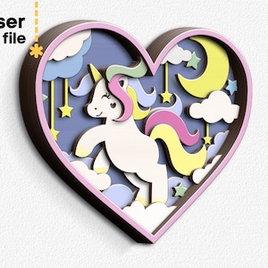 Puede incluir: Un diseño de corazón de madera cortado con láser que presenta un unicornio blanco con una melena y cola arcoíris, rodeado de nubes, estrellas y una luna creciente.