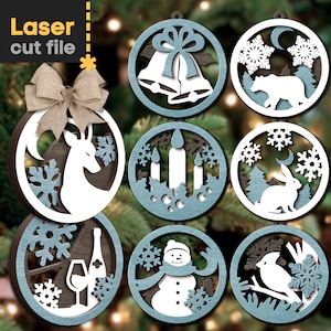 May include: Set of eight laser cut wooden Christmas ornaments with various winter themes. The ornaments are painted in shades of blue and white and feature designs such as a deer, a snowman, a bird, a rabbit, a bear, bells, candles, and snowflakes.