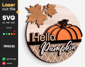 May include: A laser cut file design for a round wooden sign with the text "Hello Pumpkin" in white script. The sign features a pumpkin with an orange body and a green stem, and a brown maple leaf. The background is a light brown wood grain pattern.