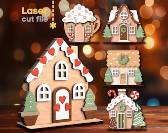 Può includere: Cinque decorazioni per case di pan di zenzero in legno con diversi design. Le case sono decorate con cuori rossi, bastoncini di zucchero e ghirlande. File di taglio laser.
