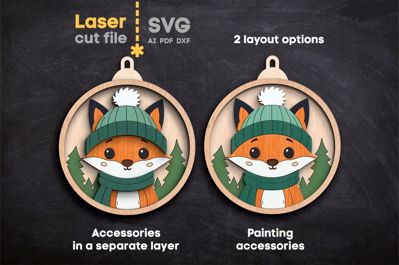 May include: A laser cut file SVG featuring two circular wooden ornament designs of a fox wearing a green knit hat with a white pom-pom and a matching green scarf. The fox is set against a background of green pine trees. Text includes Laser cut file, SVG, AI PDF DXF, 2 layout options, Accessories in a separate layer, and Painting accessories.