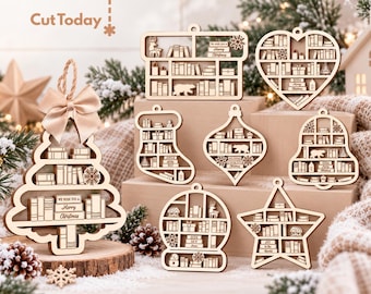 May include: A collection of laser-cut wooden Christmas ornaments in various shapes including a tree, heart, stocking, bell, star, and globe. Each ornament features miniature shelves filled with books, small gifts, and bears, with some displaying text.
