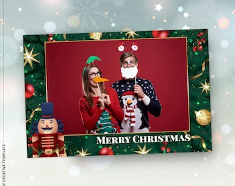May include: A Christmas-themed photo booth frame with a red background. The frame is decorated with green pine branches, gold ornaments, and red berries. The words "MERRY CHRISTMAS" are at the bottom. Two people are holding props.