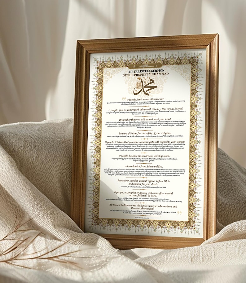 May include: A framed print of the Farewell Sermon of the Prophet Muhammad in Arabic script. The text is surrounded by an ornate gold border and includes the Arabic word for "Muhammad" in a large, decorative font.