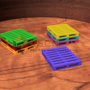 May include: A collection of colorful, miniature pallets in green, yellow, red, blue, and purple. The pallets are stacked in various configurations on a wooden surface. The image has a studio-style lighting.