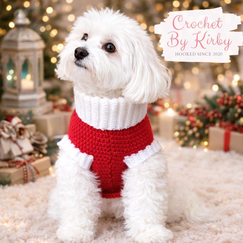 May include: A small white dog wearing a red and white crochet sweater. The sweater has a white collar and trim. The dog is sitting on a white rug with Christmas decorations in the background. The text "Crochet By Kirby HOOKED SINCE 2020" is in the upper right corner.
