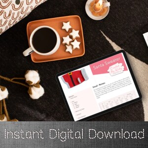 May include: A digital tablet displays a crochet pattern for a Santa sweater, with the text "Santa Sweater Crochet By Kinky". The image includes a cup of coffee, star-shaped cookies, and a lit candle on a dark patterned surface. The words "Instant Digital Download" are at the bottom.