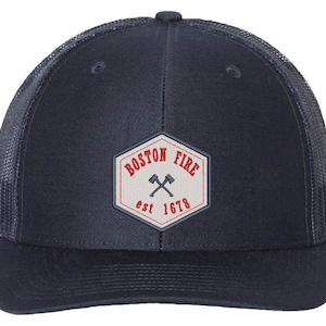May include: A navy blue trucker hat with a white patch that says "Boston Fire est 1678" with two crossed axes in the center.
