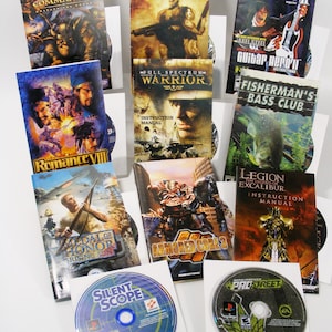 May include: A collection of PlayStation 2 video game discs and instruction manuals. Titles include "Goblin Commander," "Contra," "Guitar Hero II," "Full Spectrum Warrior," "Medal of Honor: Rising Sun," and "Armored Core 3."
