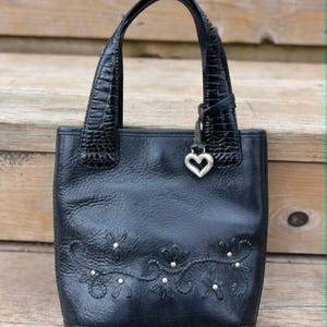 May include: A rustic wooden sign with the text "Welcome to our home" in white lettering. The sign features a distressed finish and a simple, inviting design, perfect for entryway decor.