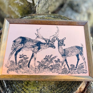 May include: A vintage copper tray with a black and white illustration of two deer in a forest setting. The tray has a wooden frame.