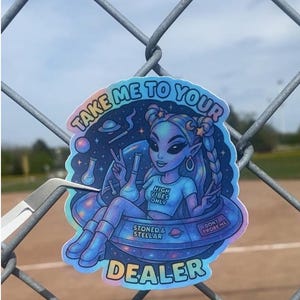 May include: A holographic sticker featuring an alien in a spaceship, with the text "TAKE ME TO YOUR DEALER." The alien is depicted with blue skin, wearing a shirt that says "HIGH VIBES ONLY."