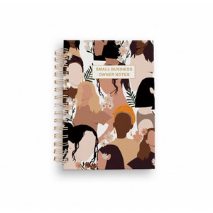 May include: A white spiral bound notebook with a colorful pattern of women's faces and flowers. The text "SMALL BUSINESS OWNER NOTES" is printed on the cover.
