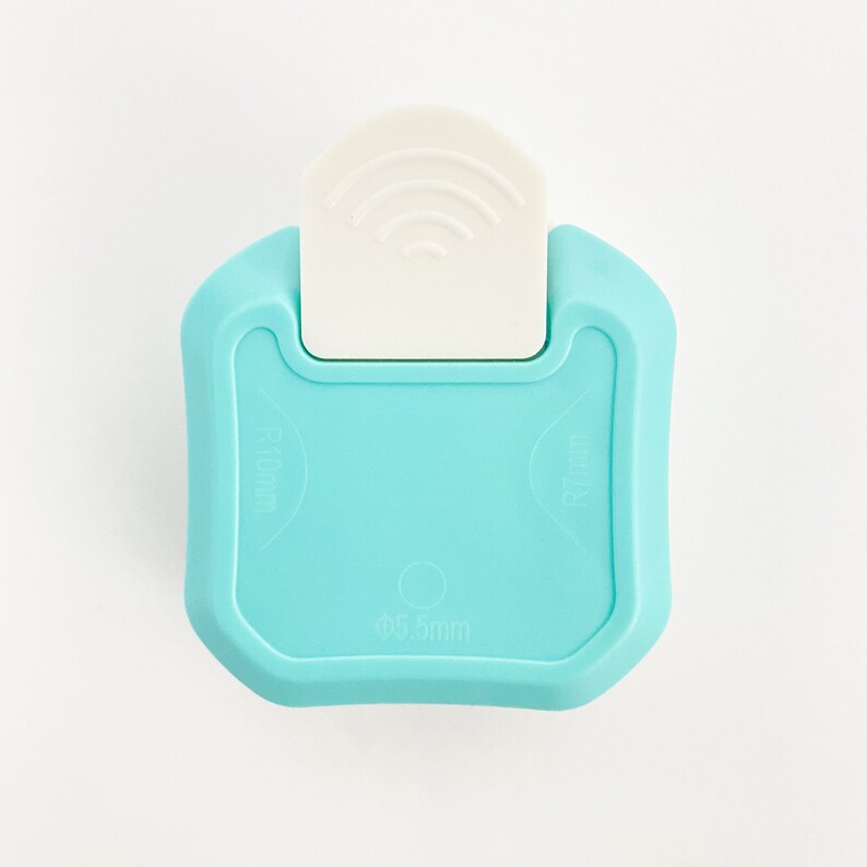 May include: A light blue plastic paper punch with a white lever. The punch has a 0.55mm hole and is labeled "R18mm" and "R10mm".
