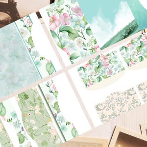 May include: A collection of printed paper sheets featuring various floral patterns in shades of pink, light blue, and green. The designs include watercolor-style flowers, leafy foliage, and soft landscape scenes with clouds, presented in multiple rectangular shapes.