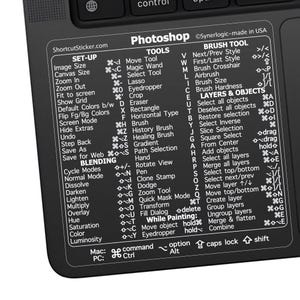 May include: A black and white keyboard sticker with Photoshop shortcuts for various tools and functions. The sticker includes keyboard shortcuts for tools like Move Tool, Magic Wand, Lasso, Eyedropper, Crop, Eraser, Rectangle, Brush, History Brush, Healing Brush, Gradient, Path Selection, Hand, Rotate View, Pen, Clone Stamp, Dodge, Zoom Tool, Quick Mask Mode, Transform, Fill Dialog, Move Object, and Eyedropper. The sticker also includes keyboard shortcuts for layers and objects, such as Select All Objects, Deselect All Objects, Restore Selection, Select Inverse, Slice Selection, Square Select, From Center, Add Objects, Select All Layers, Merge All Layers, Select Top/Bottom, Select Next/Prev, Move Layer, Move Top/Bottom, Create Layer, Group Layers, Ungroup Layers, Merge & Flatten, and Combine.