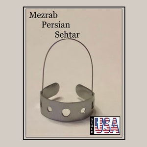 May include: A silver metal mezrab for a Persian Sehtar, a stringed musical instrument. The mezrab has a handle and a flat, perforated surface.