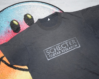 Camiseta vintage de los 90 de Schester Guitar Research, talla XL. Camiseta vintage negra desteñida de música, talla XL.