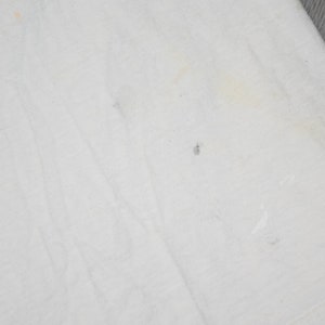 May include: White cotton fabric with several small stains.